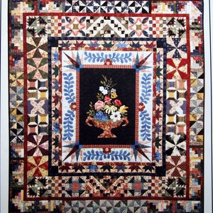 May include: A quilt pattern featuring a floral centrepiece with a vase and a border of stars, squares, and other geometric shapes. The pattern is titled "The Lincoln Quilt" and is from Buttercup Quilts.