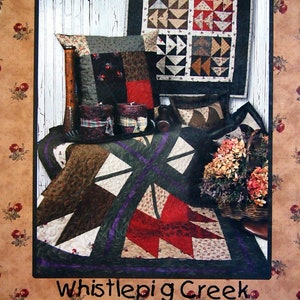 May include: A quilt pattern book titled "Completely Charming" with a subtitle "Pillows and Toppers for Charm Packs". The book cover features a quilt with a red, white, and brown color scheme. The book is published by WhistlePig Creek Productions.
