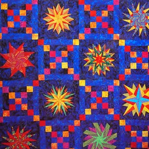 May include: A book cover titled "Quick-Strip Paper Piecing" by Peggy Martin. The cover features a blue background with colorful starburst and square block patterns in red, orange, yellow, and blue. The text "For Blocks, Borders & Quilts" is at the bottom.