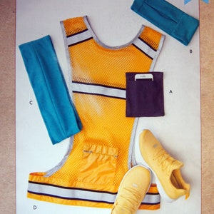 May include: A sewing pattern for a yellow safety vest, a blue headband, a blue armband, and a black belt. The pattern is called "kwik sew" and the number is 10821. The text "ARMBAND, HEADBAND, BELT AND VEST" is printed on a blue banner at the bottom of the image.