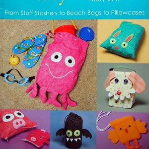 May include: A book titled "Fast Fun & Easy Fabric Critter Bags" by Mary Link. The book cover features a variety of colorful fabric bags with animal faces, including a pink octopus, a green bunny, a white dog, a black bat, and an orange bird.