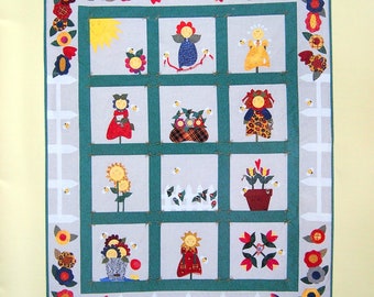 May include: A quilt pattern featuring a green border with a white picket fence and a variety of colorful flower and child figures. The title of the pattern is "Flower Children Quilt" and the designer is "Carol Burger".