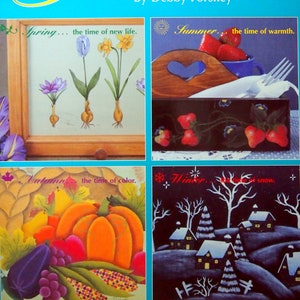 May include: A book cover titled "Touches of Seasons" by Debby Forshey. The cover features four illustrations depicting the four seasons: spring with blooming flowers, summer with strawberries and a wooden heart, autumn with a pumpkin and corn, and winter with a snowy village.