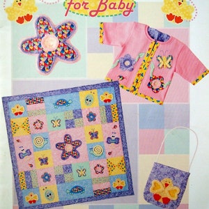 May include: A sewing pattern for a baby quilt, cardigan, and a small bag. The quilt is made of squares with different designs, including butterflies, flowers, and snails. The cardigan is pink with yellow trim and features a butterfly and flower applique. The bag is purple with a yellow chick applique. The pattern is titled "Warm Fuzzies for Baby".