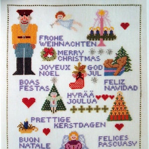 Puede incluir: Sampler navideño de punto de cruz con un cascanueces, ángeles, árboles de Navidad y saludos festivos en varios idiomas. El diseño incluye corazones, copos de nieve y un calcetín.