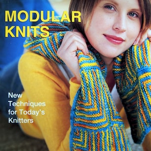 May include: The cover of a book titled "MODULAR KNITS" shows a woman with a colourful knitted scarf. The scarf is striped with blue, yellow, and orange. The book's subtitle reads "New Techniques for Today's Knitters" by Iris Schreier.