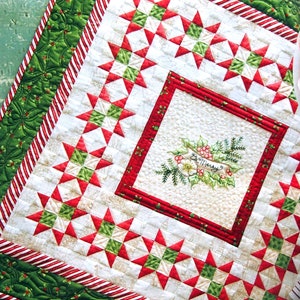 May include: A festive Christmas quilt with a star pattern in red, green, and white. The quilt features a central square with embroidered holly and the words "Be Merry". The border has a candy cane stripe design.