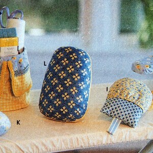 May include: A collection of sewing and ironing accessories, including a yellow and blue organizer, a blue ironing board cover, a blue and yellow iron rest, and a blue and yellow padded sleeve board. The accessories are decorated with floral and geometric patterns.