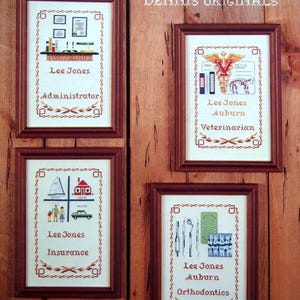 May include: A cross-stitch pattern book titled "MORE PROFESSIONALS 2" by Dennis Originals. The cover features four framed cross-stitch designs depicting various professions, including administrator, veterinarian, insurance, and orthodontics. The book is labeled "BOOK 15".
