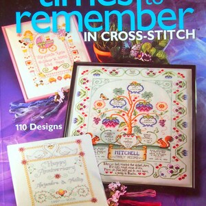 Puede incluir: Un libro titulado "Times to Remember in Cross-Stitch" con 110 dise&ntilde;os. La portada presenta tres patrones de punto de cruz: un cochecito de beb&eacute;, un &aacute;rbol geneal&oacute;gico y un aniversario de boda.