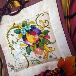May include: A white linen pillow with a colorful embroidered design of a flower with a bee and dragonfly. The pillow has a burgundy border.