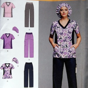 May include: A woman wearing a floral print scrub top, matching hat, and navy blue pants. The scrub top has a V-neck and black side panels. The image also shows diagrams of scrub tops, pants, and hats in pink, purple, and navy blue.