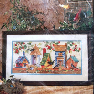 May include: Bucilla counted cross-stitch kit, 41127, titled "Birdhouses". The kit includes 14 count aida cloth, cotton embroidery floss, needle, and easy-to-follow instructions with chart. The image shows a colorful cross-stitch design of birdhouses with birds and cherries.