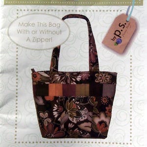 May include: A quilting pattern for a brown and floral tote bag with the title "ps029 Baja Traveler" and the text "Make This Bag With or Without A Zipper!"  Designed by Penny Sturges.