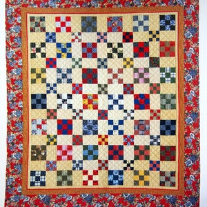 May include: A quilt with a patchwork design featuring a variety of colors and patterns, including red, blue, green, and yellow. The quilt is pieced by Alex Anderson and machine-quilted by Patti Hammett.