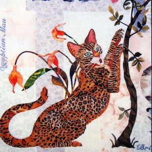May include: A colorful illustration of an Egyptian Mau cat with a spotted coat, reaching towards a tree branch. The cat has green eyes and is surrounded by stylized flowers. The text "Egyptian Mau" is visible.