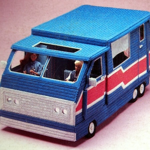 May include: A blue and white camper van with a red stripe and a white roof. The van has two windows and a door. There are two figures inside the van.
