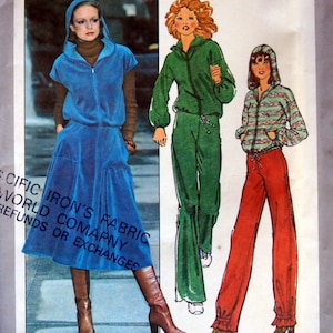 May include: Three fashion illustrations of women wearing different styles of hooded tops and trousers. The first woman is wearing a blue hooded top with a skirt and boots. The second woman is wearing a green hooded top and matching trousers. The third woman is wearing a striped hooded top and red trousers. The text at the bottom of the image reads "Iron's Fabric World Company Specific Refunds or Exchanges".