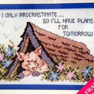 May include: Cross stitch pattern featuring a pink pig hiding in a brown house with the text "I only procrastinate... so I'll have plans for tomorrow".