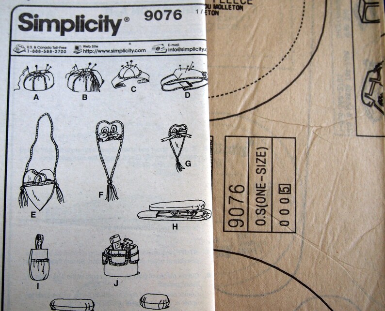 May include: A Simplicity sewing pattern, number 9076, featuring various craft projects. The pattern includes illustrations of pincushions, bags, and other accessories. The pattern is printed on white paper with black text and illustrations. The pattern is one size.