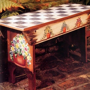 May include: A wooden bench with a checkerboard top and painted floral designs. The bench has a distressed finish and is painted in shades of white, black, brown, green, yellow, orange, and red.