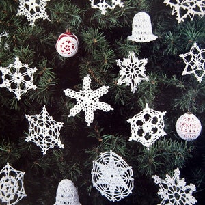 May include: A collection of white, crocheted Christmas ornaments, including snowflakes, bells, and round baubles, displayed on a green Christmas tree. The ornaments vary in design, with intricate openwork patterns. The overall theme is festive and handmade.