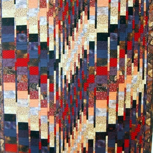 May include: A quilt with a geometric pattern of vertical stripes in shades of red, black, white, and blue. The stripes are arranged in a staggered pattern, creating a sense of movement and depth.