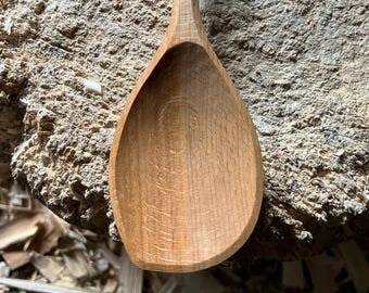 Hand carved right handed wooden cooking spoon, eleven inches long