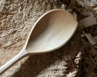 Hand carved right handed wooden cooking spoon, twelve inches long