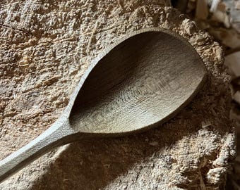 Hand carved right handed wooden cooking spoon, eleven inches long