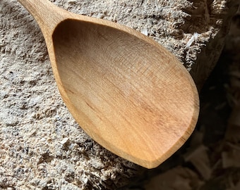 Hand carved right handed wooden cooking spoon, eleven inches long