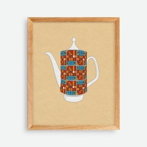 May include: A framed print featuring a white teapot with a colorful geometric pattern. The pattern includes red, blue, orange, and green squares and rectangles. The teapot has a long spout and a handle. The frame is made of light brown wood.