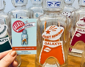 Galaxy Spaceman Syrup Bottle Enamel Pin - 2 Colors - Orange Orbit