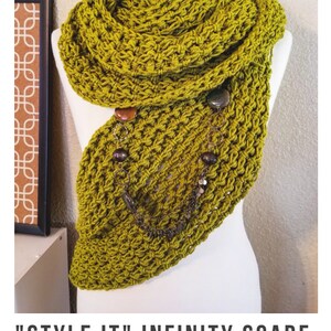 May include: A green crocheted infinity scarf with a chain and beads hanging from it. The scarf is draped over a white mannequin. "STYLE IT" INFINITY SCARF crochet pattern serendipity-as-always.com