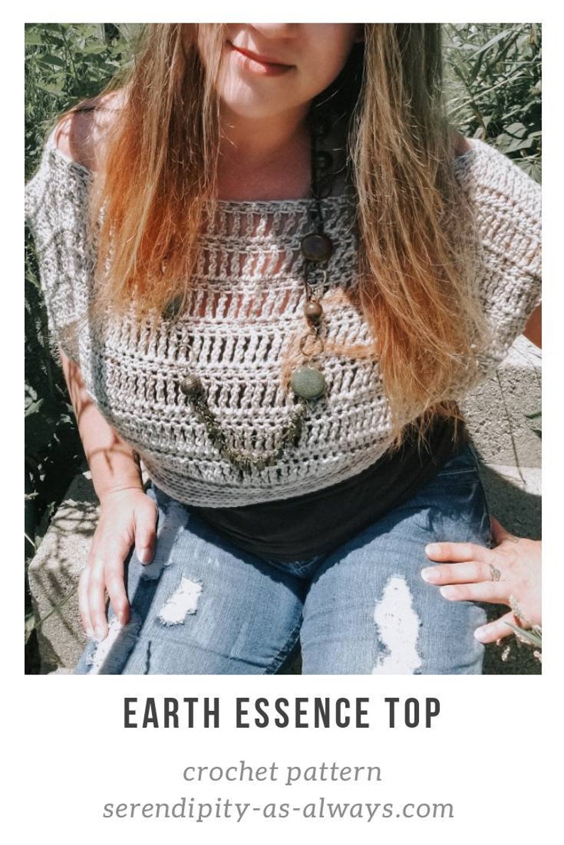 May include: A crocheted top with an off-the-shoulder design. The top is made with a light brown yarn and has a loose, airy fit. The top is worn over a black tank top and paired with blue jeans. The text "EARTH ESSENCE TOP" and "crochet pattern" is visible at the bottom of the image. The website "serendipity-as-always.com" is also visible.