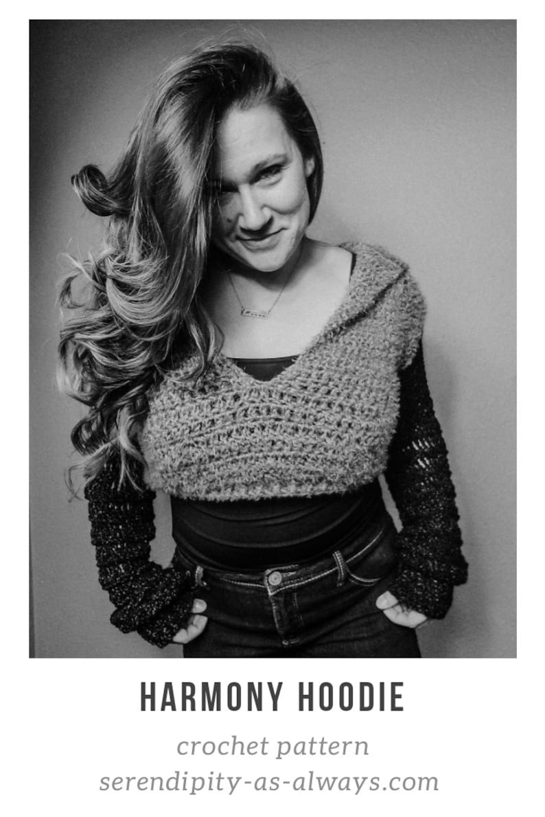 May include: A black and white photo of a person wearing a crocheted hooded top with long sleeves. The top is a cropped style and the sleeves are long and loose. The person is wearing jeans and has their hands in their pockets. The text "HARMONY HOODIE" is below the image, and the text "crochet pattern" and "serendipity-as-always.com" are below that.