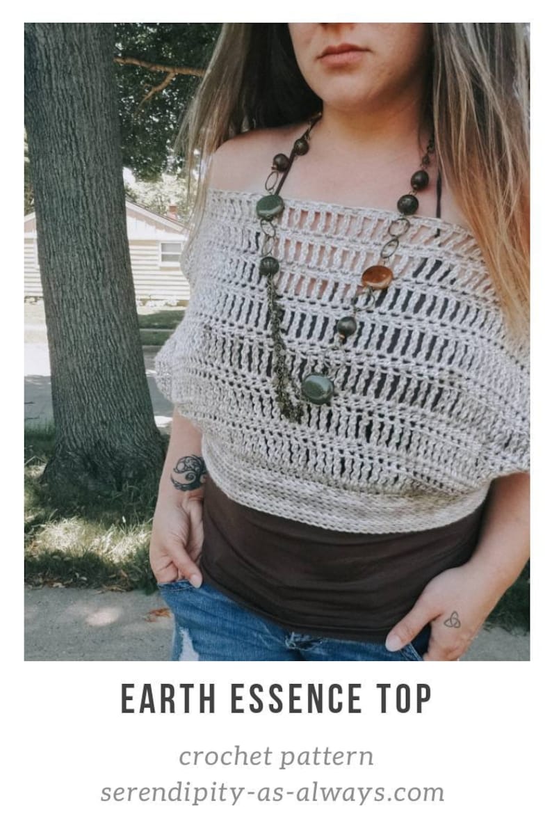 May include: A crochet top with an off-the-shoulder design, featuring a light beige color and a delicate openwork pattern. The top is paired with a brown tank top and blue jeans. The image includes the text "EARTH ESSENCE TOP crochet pattern serendipity-as-always.com".