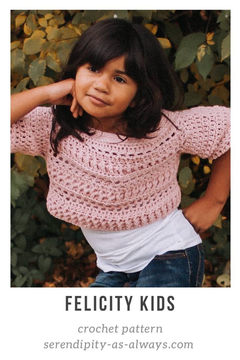 May include: A pink crochet top with a lacy pattern. The top is cropped and has short sleeves. The model is wearing the top with a white t-shirt and blue jeans. Felicity Kids crochet pattern serendipity-as-always.com