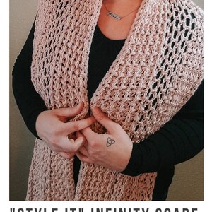 May include: A close-up of a pink crochet infinity scarf. The scarf is made with a simple stitch pattern and has a delicate, airy feel. The scarf is worn by a person with a black shirt and a silver necklace. The text "STYLE IT" INFINITY SCARF crochet pattern serendipity-as-always.com is visible at the bottom of the image.