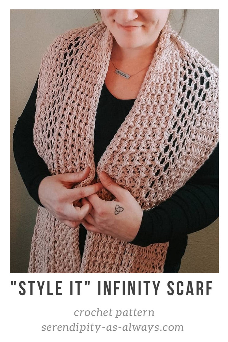 May include: A close-up of a pink crochet infinity scarf. The scarf is made with a simple stitch pattern and has a delicate, airy feel. The scarf is worn by a person with a black shirt and a silver necklace. The text "STYLE IT" INFINITY SCARF crochet pattern serendipity-as-always.com is visible at the bottom of the image.