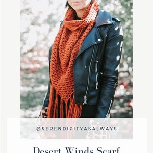 May include: A woman wearing a black leather jacket and a rust-colored crochet scarf with fringe. The scarf is a triangle shape and has a crocheted pattern. The text "@serendipityasalways" is below the image. The text "Desert Winds Scarf" is below the text "@serendipityasalways". The text "Crochet Pattern" is below the text "Desert Winds Scarf". The text "PDF Digital Download" is below the text "Crochet Pattern".