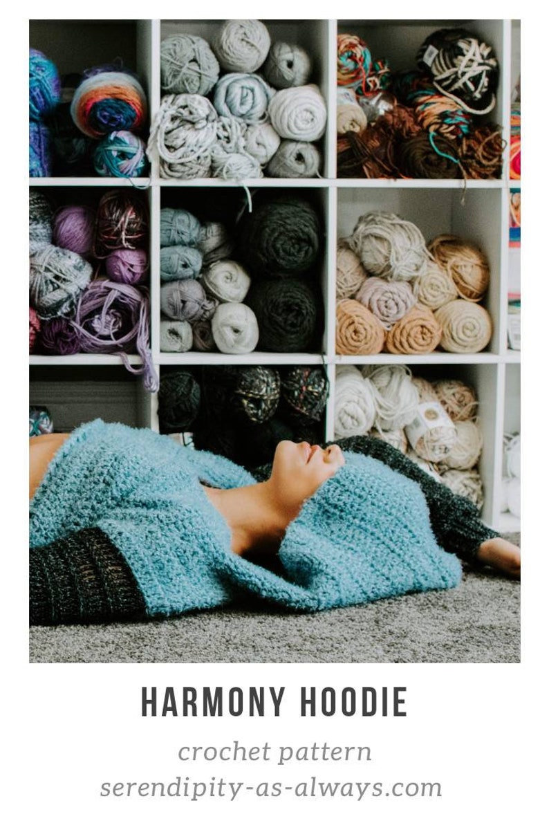 May include: A blue crocheted hoodie with a large hood, lying on a gray surface. The image is accompanied by the text "HARMONY HOODIE crochet pattern serendipity-as-always.com".