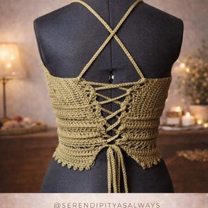 May include: Olive green crochet top with a crisscross back and lace-up detail, displayed on a black mannequin. The top features a scalloped edge and thin straps. Text on the image reads "Callisto Top - Crochet Pattern - PDF Digital Download".