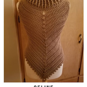 May include: A brown crocheted cowl with a high neck and a triangular shape. The cowl is displayed on a mannequin. The text "CELINE crochet pattern serendipity-as-always.com" is below the image.