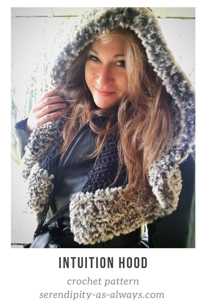 May include: A woman wearing a gray and black hooded crocheted scarf. The scarf has a fluffy texture and is worn over a black jacket. The text "INTUITION HOOD crochet pattern serendipity-as-always.com" is visible at the bottom of the image.