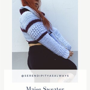 May include: A crochet sweater pattern in blue and purple stripes. The pattern is available as a digital download. The text "Maise Sweater" and "CROCHET PATTERN PDF DIGITAL DOWNLOAD" is visible on the image. The image also includes the text "@SERENDIPITYASALWAYS".