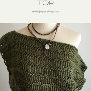 May include: A crochet top in a dark green color, with a loose, open-weave pattern. The top is shown on a mannequin, with a brown leather cord necklace with a silver pendant.