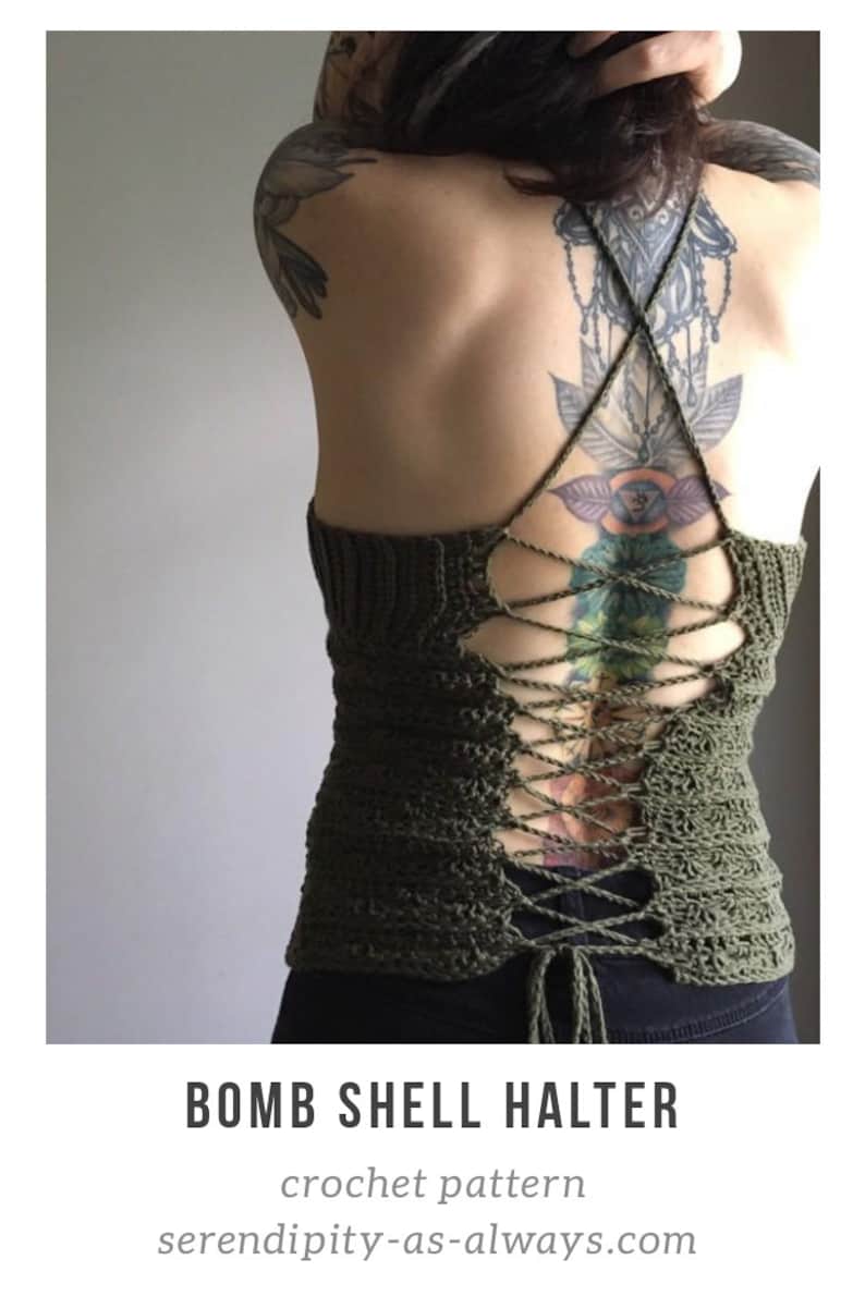 May include: A green crochet halter top with a lace-up back. The top is tied at the back with a long, thin cord. The top is worn by a person with a large tattoo on their back.