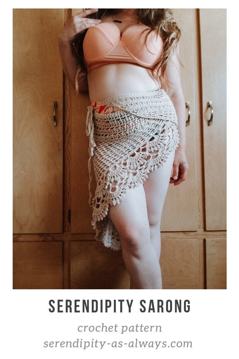 May include: A crocheted sarong in a beige color with a floral pattern. The sarong is tied at the waist and drapes down the legs. The text "SERENDIPITY SARONG" and "crochet pattern" is visible at the bottom of the image. The text "serendipity-as-always.com" is also visible.