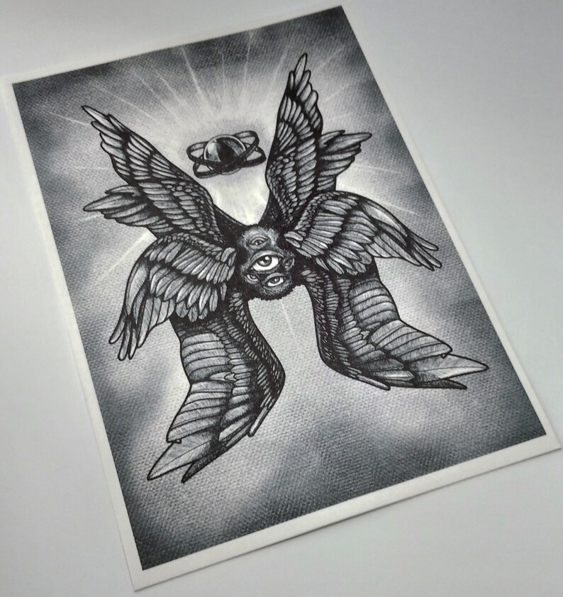 May include: Black and white illustration of a seraphim angel with multiple wings and eyes. The artwork features detailed shading and a halo-like element above the angel. The image is printed on a textured paper.